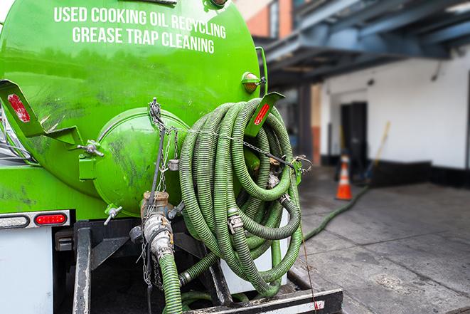 a technician pumping a grease trap in a commercial building in Congers